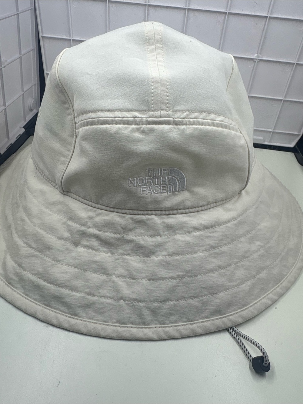 The North Face white nylon bucket hat in size L